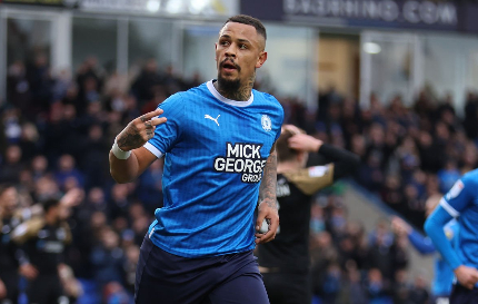 FOOTBALL-Clarke-Harris double earns a Posh point.